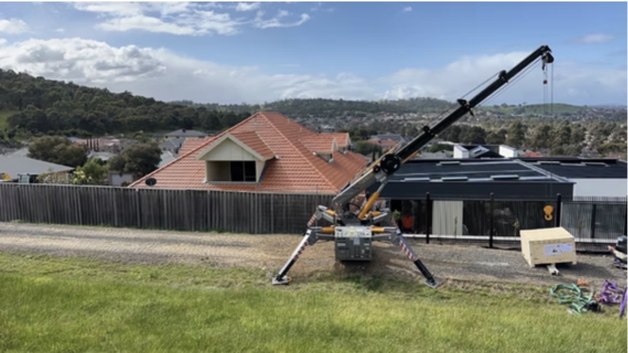 Spider crane on open residential site with outriggers deployed