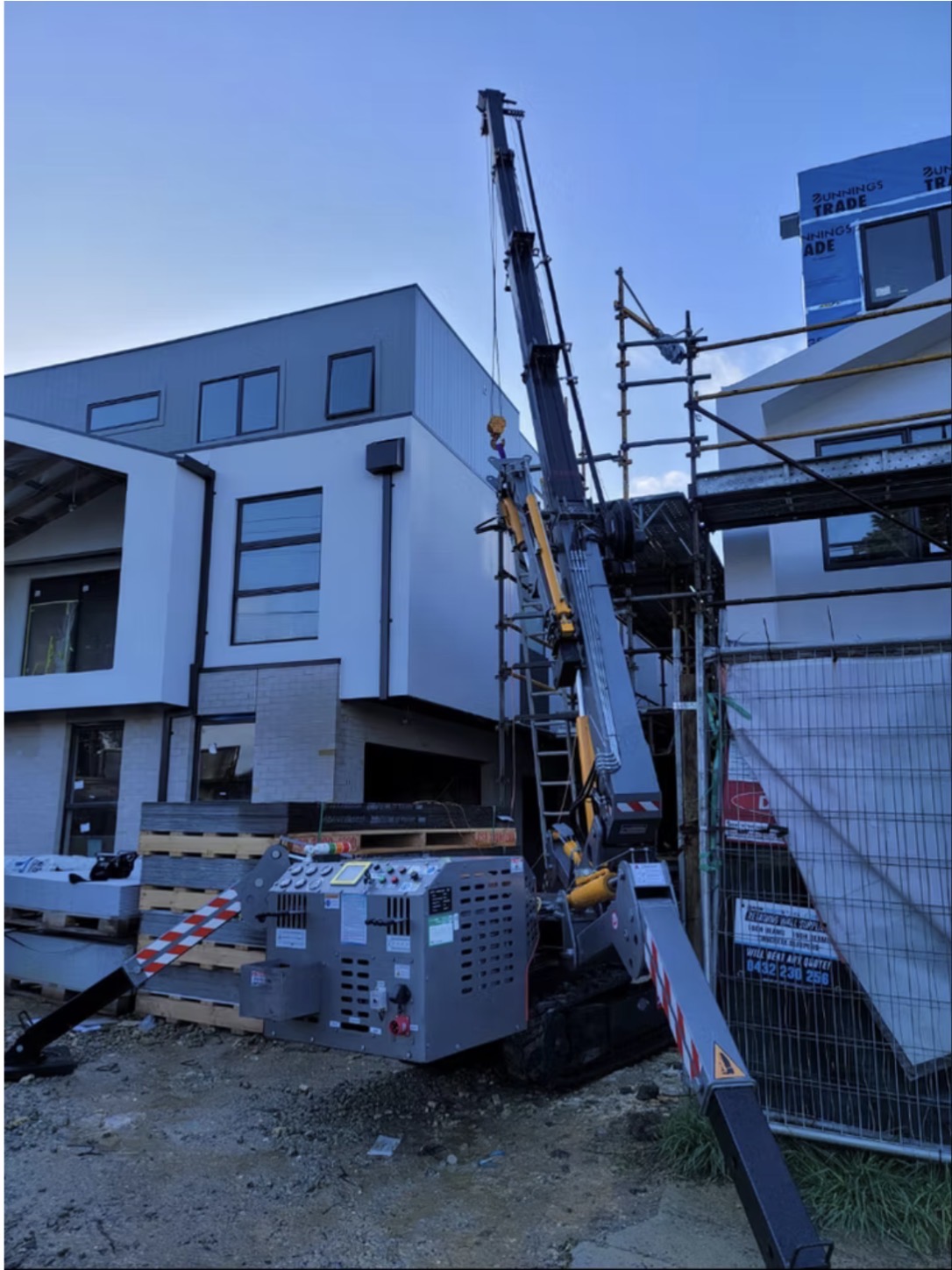 Spider crane in tight urban construction site between buildings